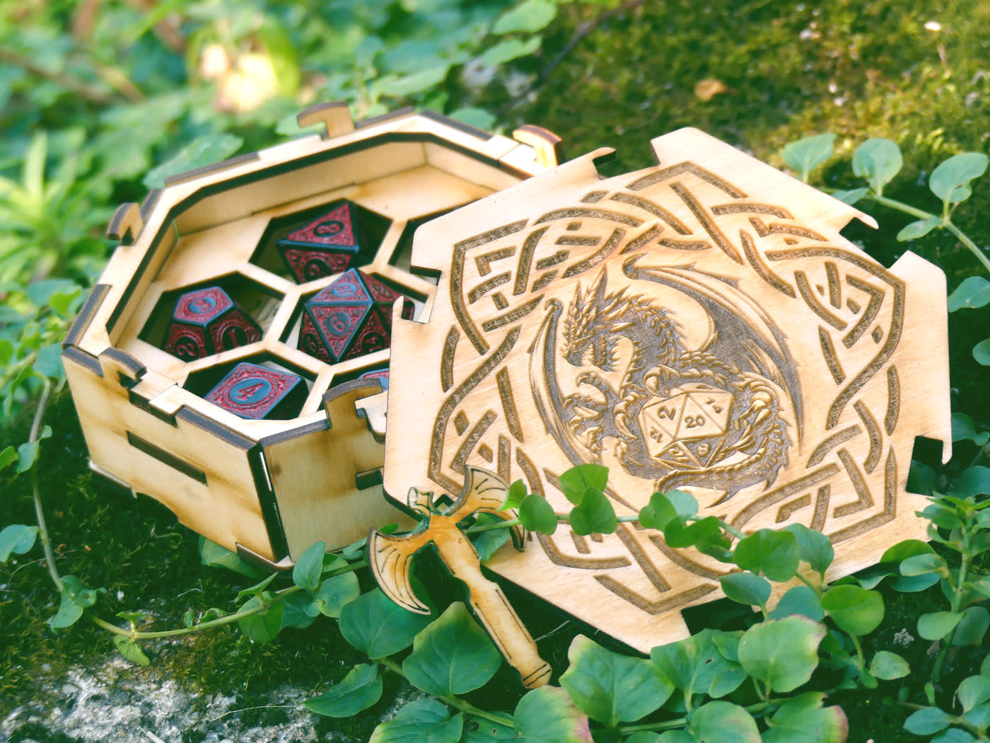 The dice box open, showing the honeycomb insert with one hexagonal cell per die