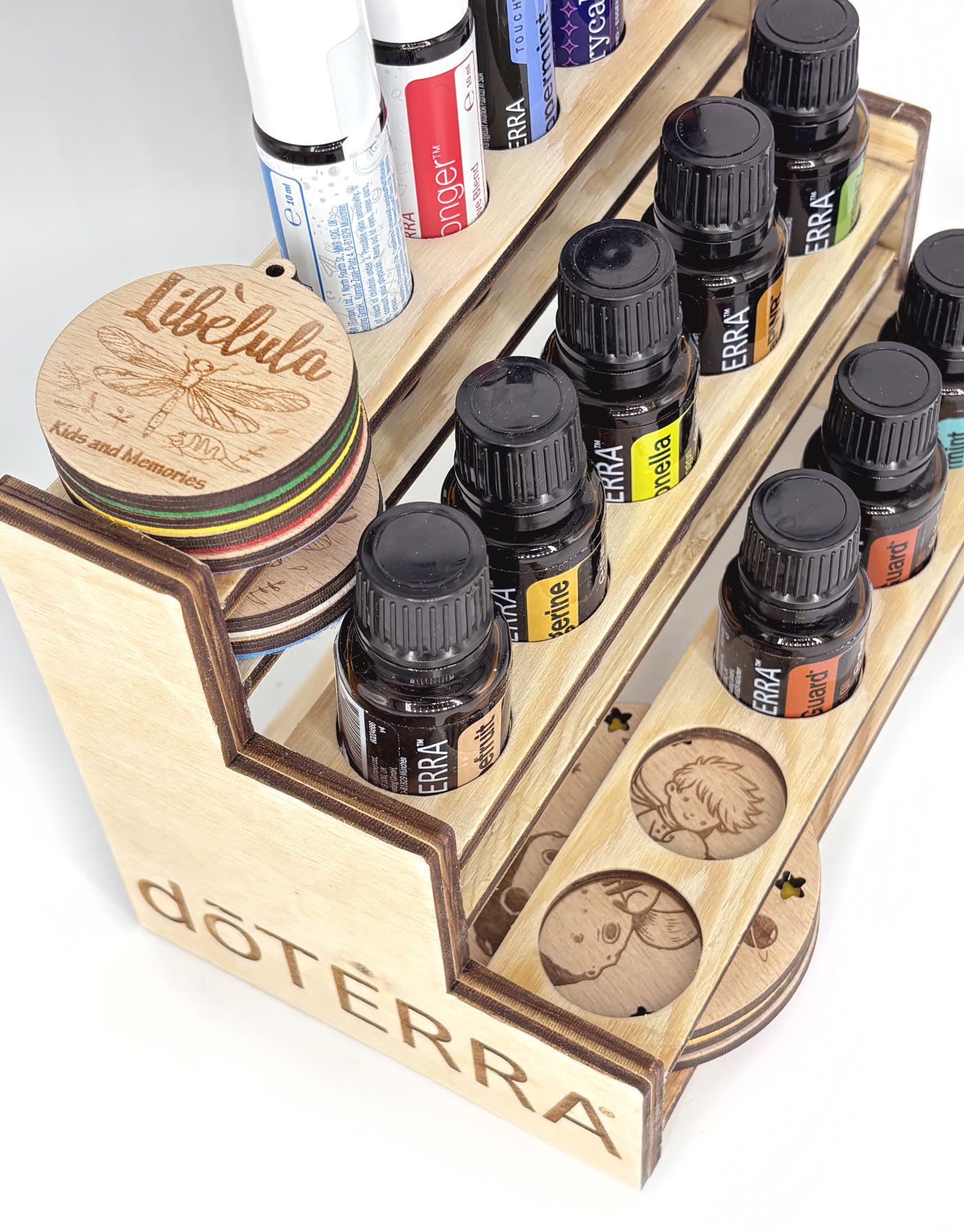 Close-up of the engraved botanical discs recessed into the lowest tier of the rack